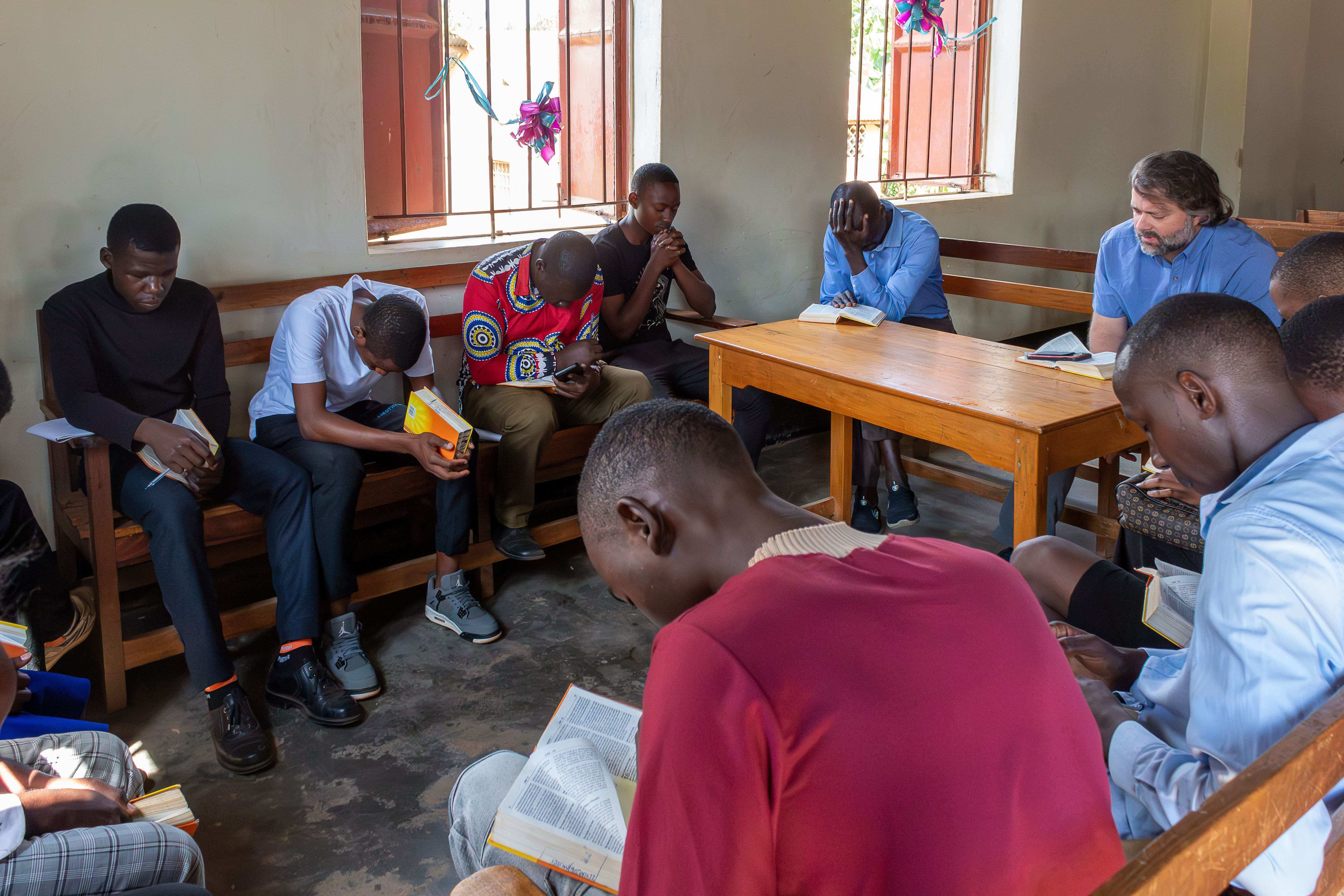 Circle of young adults praying